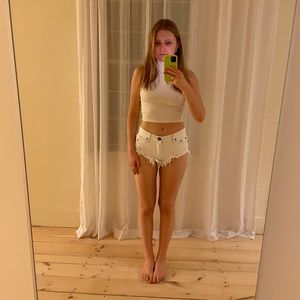 Distressed white jean shorts